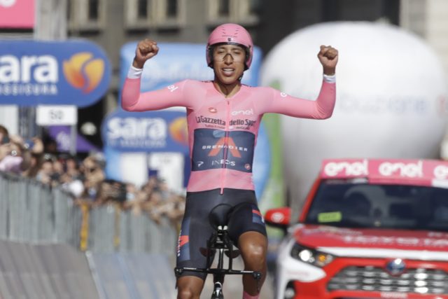 Egan Bernal, arms aloft, crossing finish line for the Giro win. 