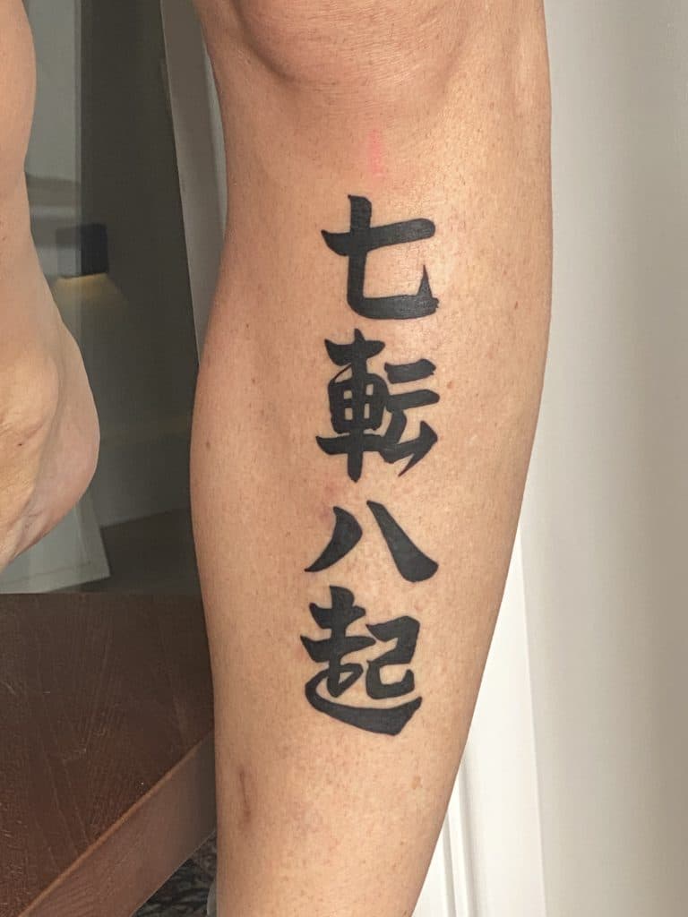 Fall seven times, get up eight tattoo written in Japanese letters nanakorobi yaoki