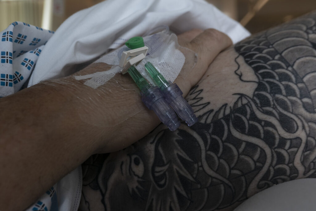 Trauma. Healing. Growth. Intravenous drip in my hand, backdrop of dragon tattoo